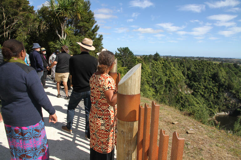 Archbishops and Fono pilgrims view the precipice where women, children and men met their deaths during a siege by warring tribes from Waikato.